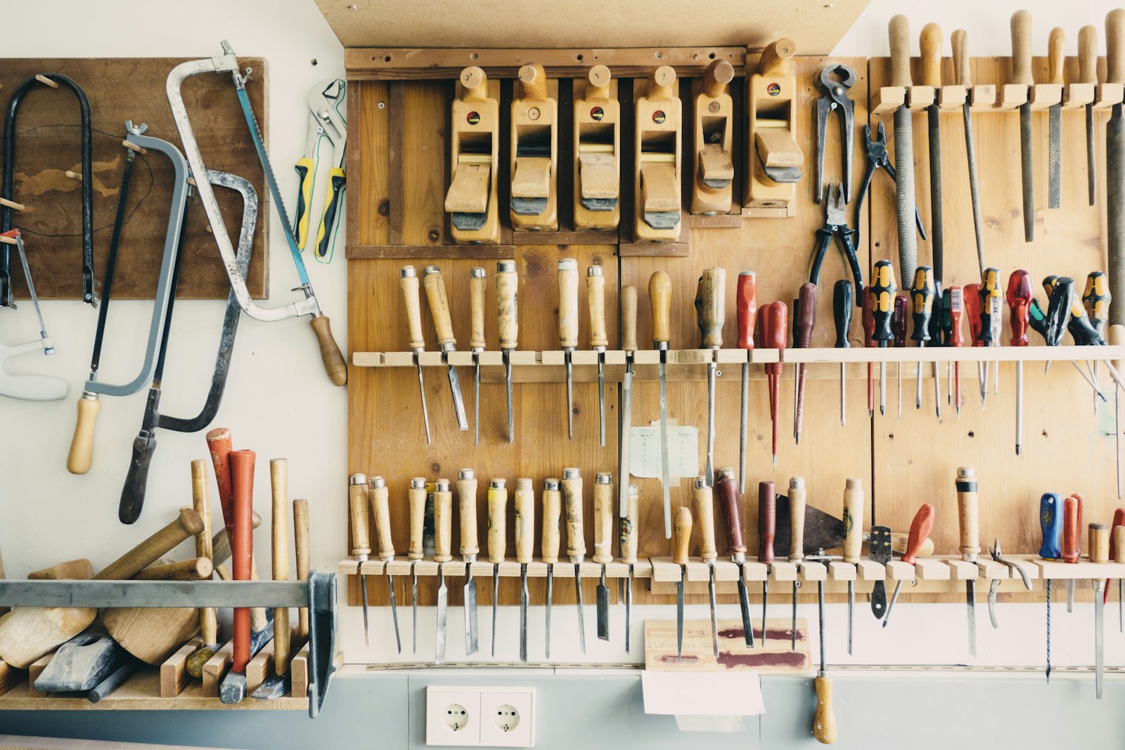 Assorted equipment on a workshop tool rack. Photo by Barn Images on Unsplash, used under the free Unsplash License.