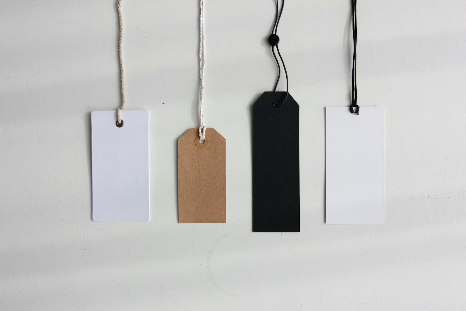 Blank price tags, the true cost of a good made visible. Photo by Angele Kamp on Unsplash, used under the free Unsplash License.