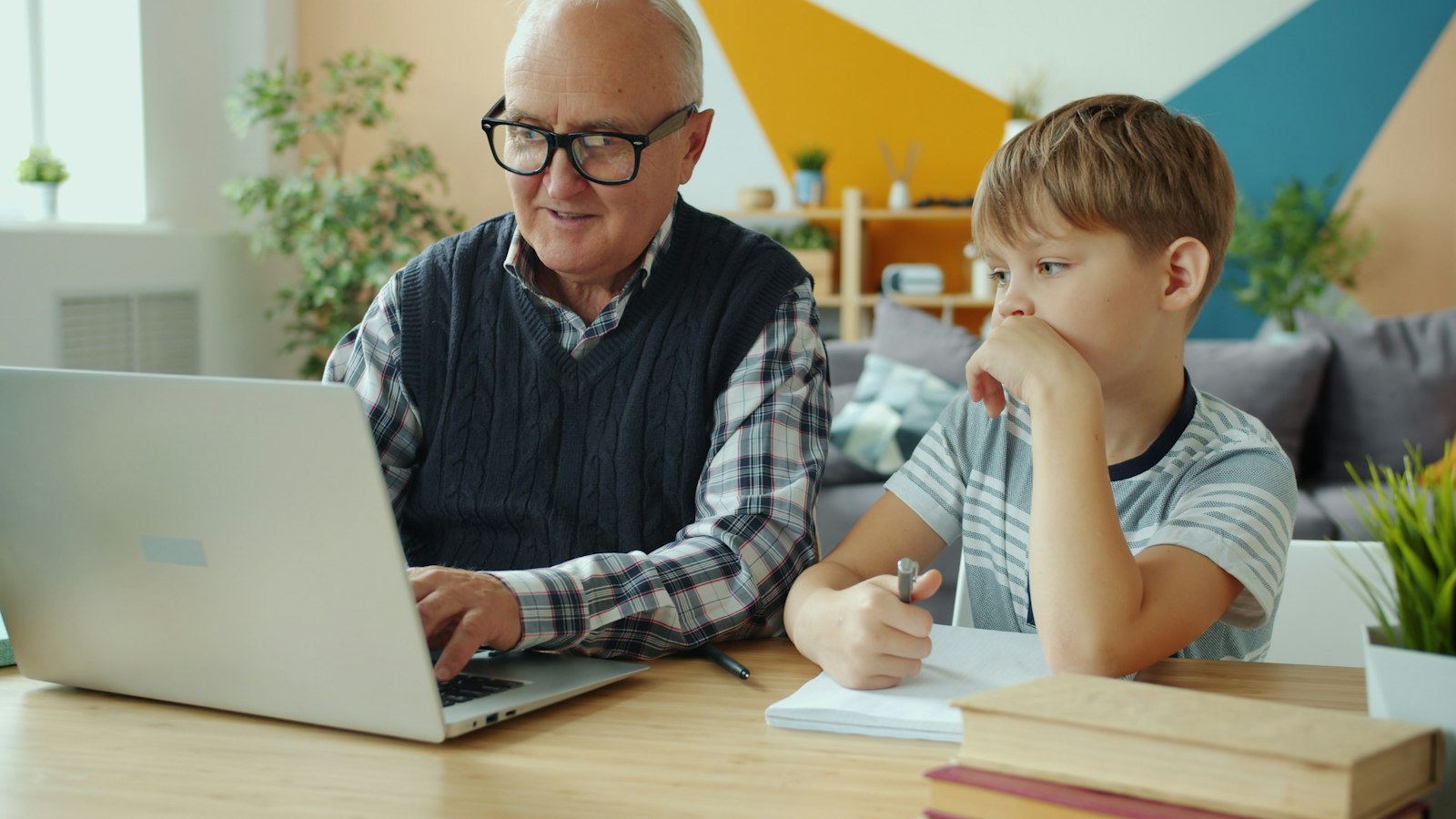 A grandfather and grandson learning together at a laptop, a lifelong rhythm across generations. Photo by Vitaly Gariev on Unsplash, used under the free Unsplash License.