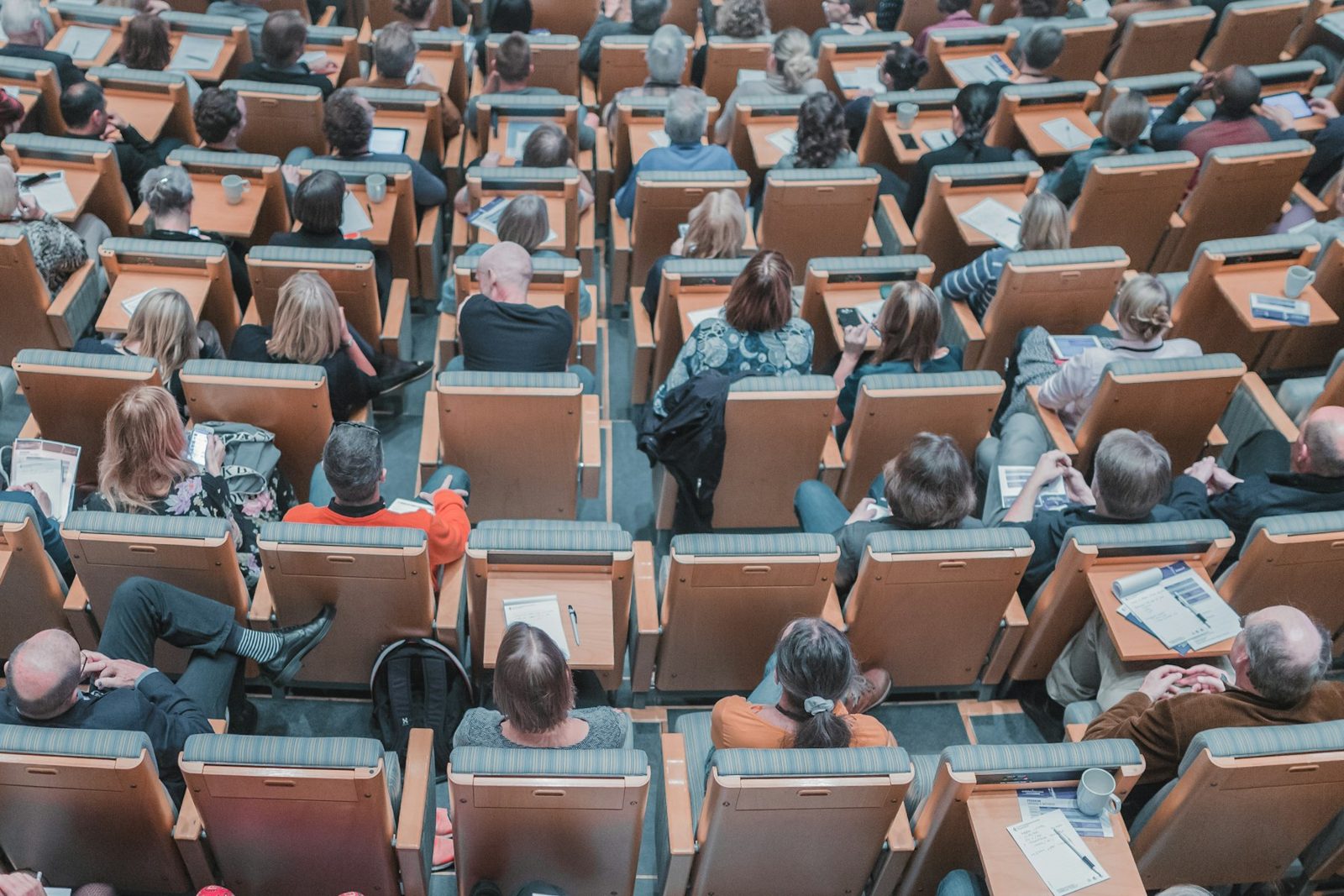 A large group of people seated in rows at a meeting