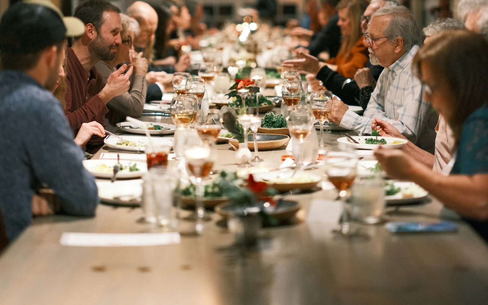 Neighbours sharing a meal together at a long table